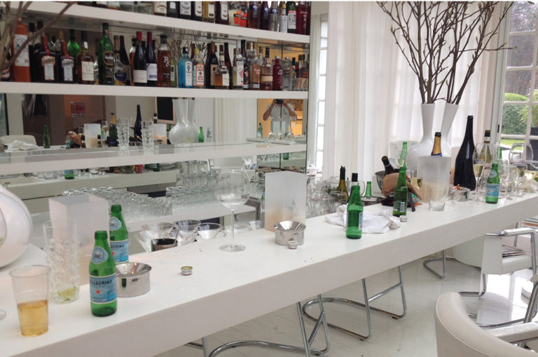 Modern bar lounge with empty glasses and bottles after a celebration.